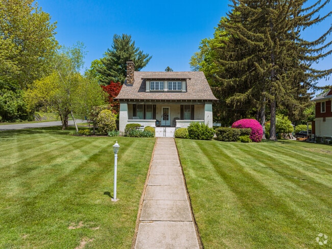 Cottage-style homes with sculpted lawns add charm to Goshen streets.
