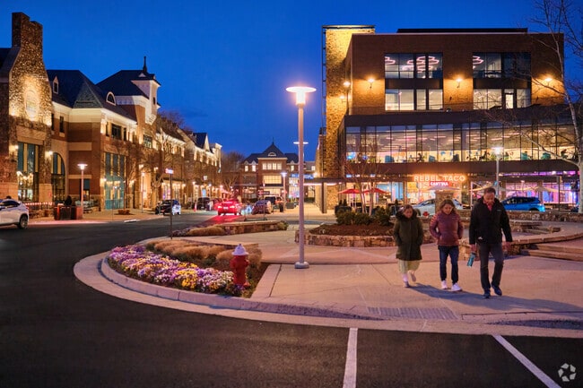 A family enjoys an evening walk through Brambleton town center.