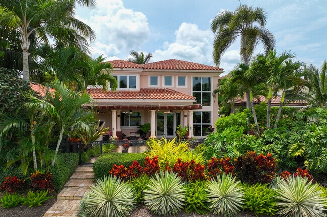 Multi level Mediterranean style single family home with large front garden in Palm Beach Lakes.