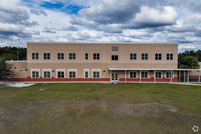 A sizable awning shields kids from inclement weather on the south side when leaving school.