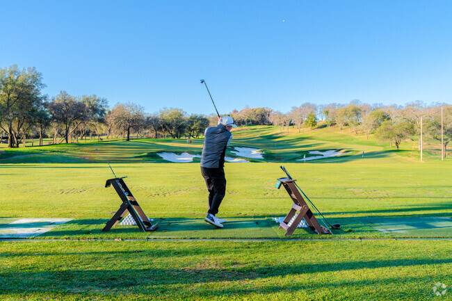 Man practices his drive as the sun rises over Granite Bay Golf Club near Orangevale.