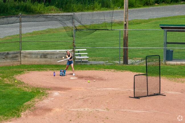 Hitting softballs is a fun way to practice on the field at Cass Park in Northwest Ithaca.