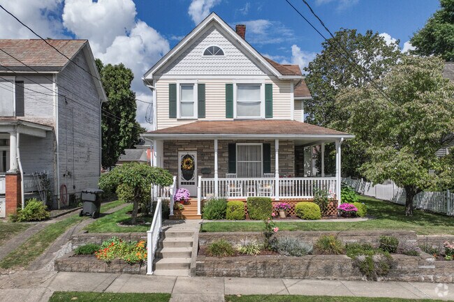 Zelienople homes features pitched roofs, covered porch and classic design.