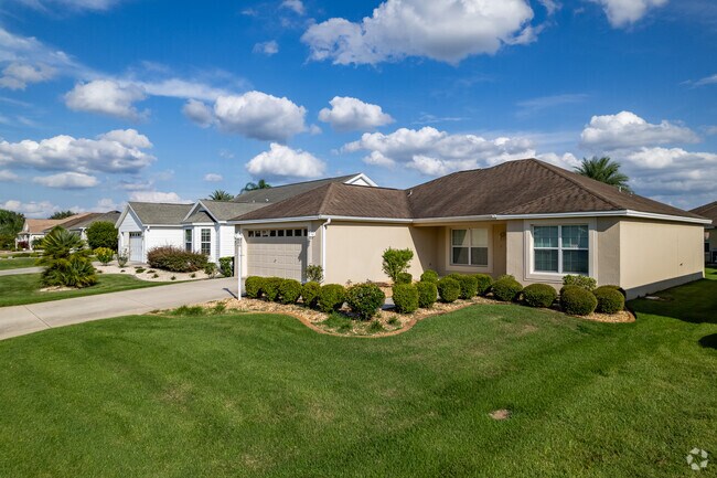 A row of Minimal Traditional homes overlooking a golf course in Village of Saint Charles.