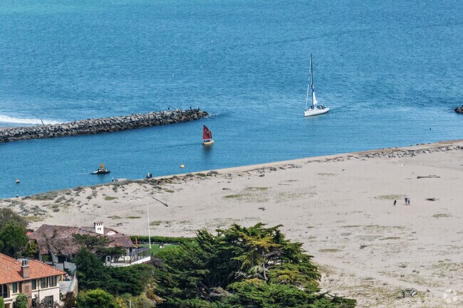 Sailboats glide along Upper Seabright's serene coast, perfect for a day on the water.