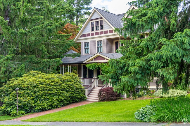 A Queen Anne styled home peaks out from its lush green surroundings in Munroe Hill.