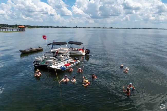 Local residents will often anchor their boats and wade in the shallow water in Lake Jackson.