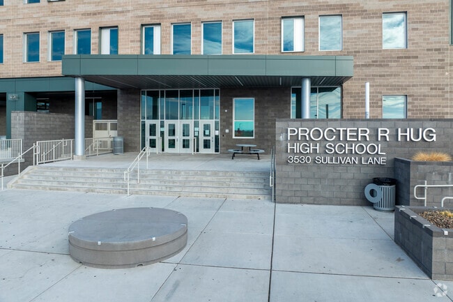 The school sign and front doors at Procter R Hug High School.