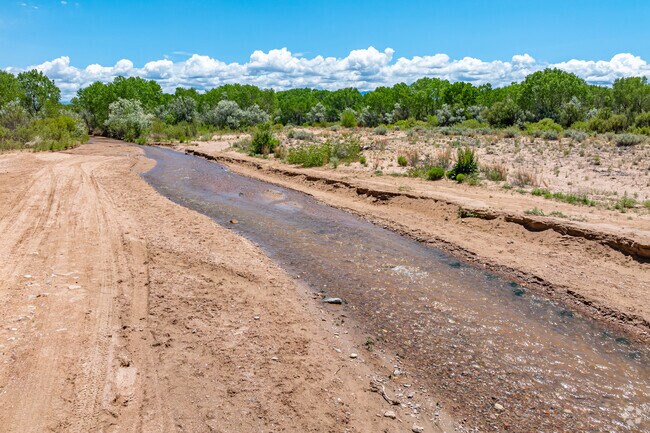The Pojoaque River threads the valley near Jacona, supporting farms and wildlife.