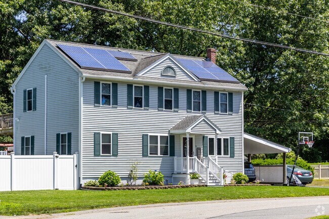 A contemporary, Colonial inspired home in the Pawtucketville neighborhood with solar panels.