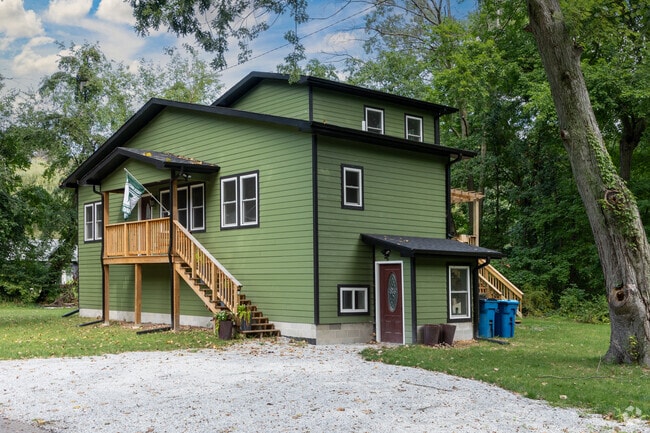 This green saltbox style home is nestled in the thick woods of Beverly Shores near the dunes.