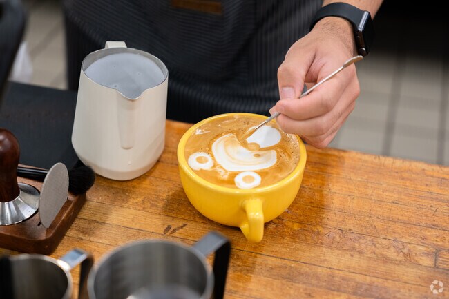 Baristas at Mendon Brunch on the Brook serve cappuccinos with latte art.