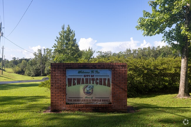 Rustic-style welcome sign marks the gateway to Wewahitchka, Florida.