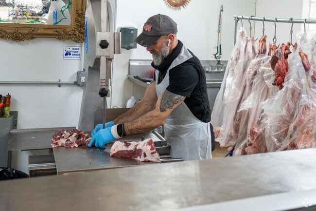 The butcher at Meat House, on Harlem Ave. in Worth, IL, prepares an order for a customer.