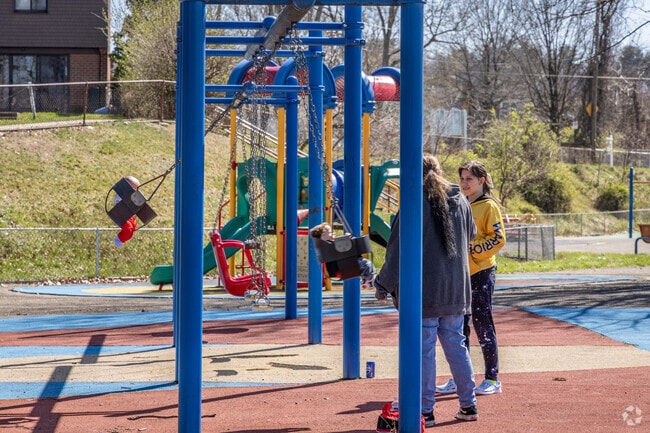 Mothers meet for some swing time with their kids at McGonigle Park.