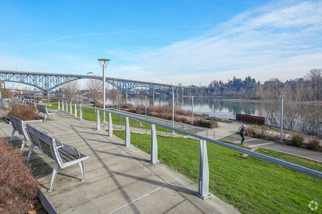 A waterfront walkway runs along the Willamette River in South Waterfront, Portland.