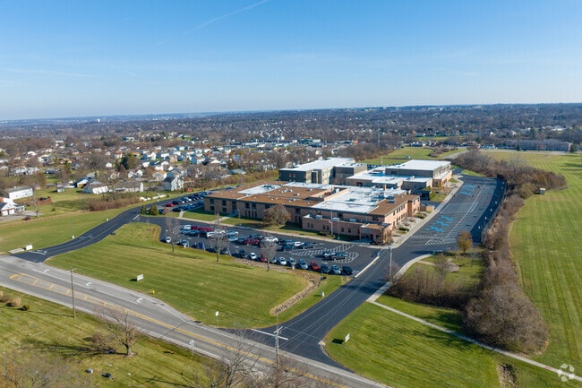 Many students come outside for recess on the side of the building.