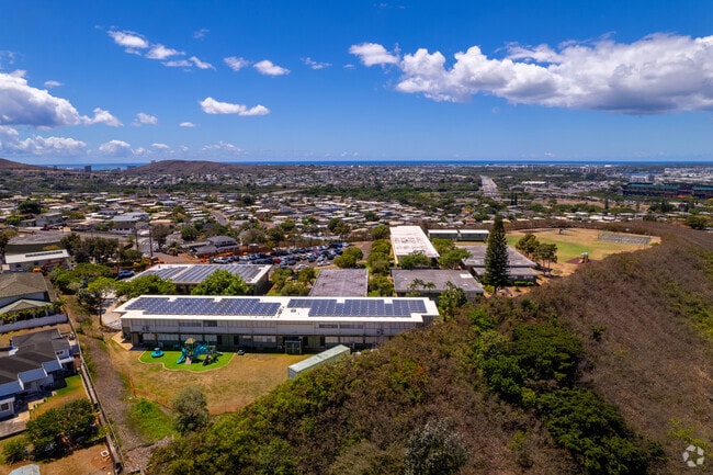 Gustav H Webling Elementary School is surrounded by trees and greenery in Siea, HI.
