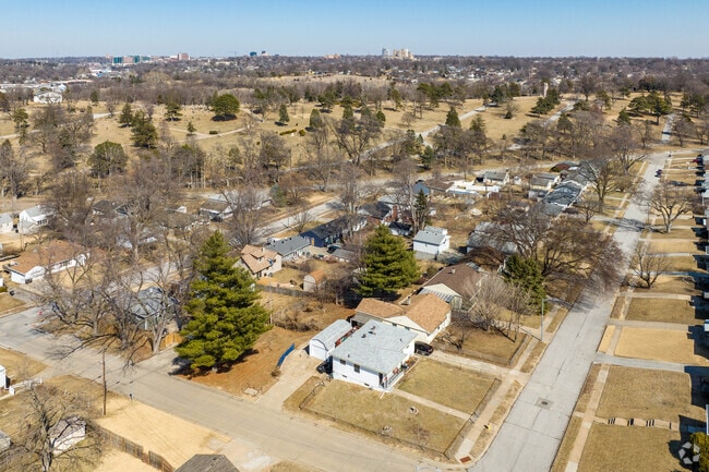 Neighborhood streets with Westlawn-Hillcrest Memorial Park Cemetery in the background.