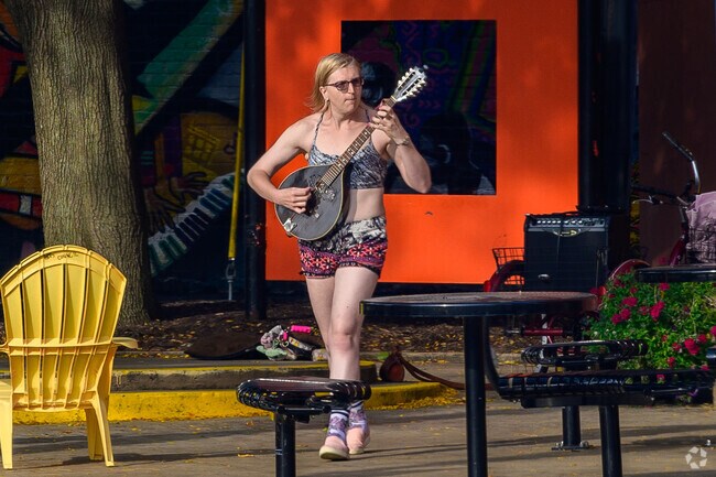 A local performer uses Turner Mini Park as a venue for an impromptu concert in Old Town.