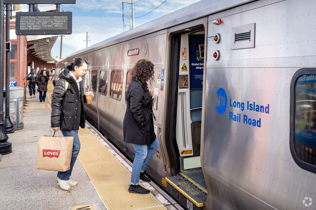 Passengers board the train to New York City's Penn Station at Syosset.