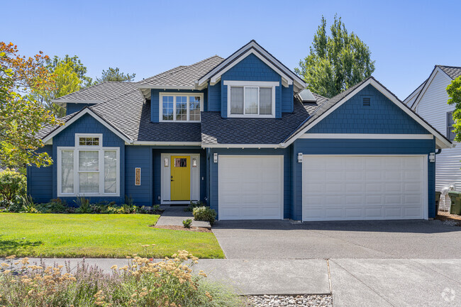 A bright yellow door adorns this large traditional home in the Oak Creek neighborhood.