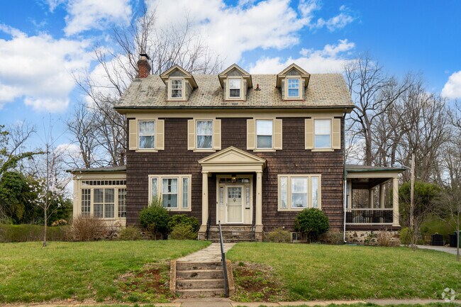 Two-story Cape Cod style homes line Ten Hills in Baltimore, Maryland.