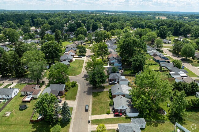Mature trees line the quiet neighborhood of Perry Heights.