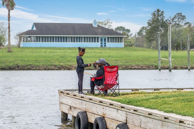 A father and daughter cast a line along the banks of West Galveston Bay near Santa Fe.