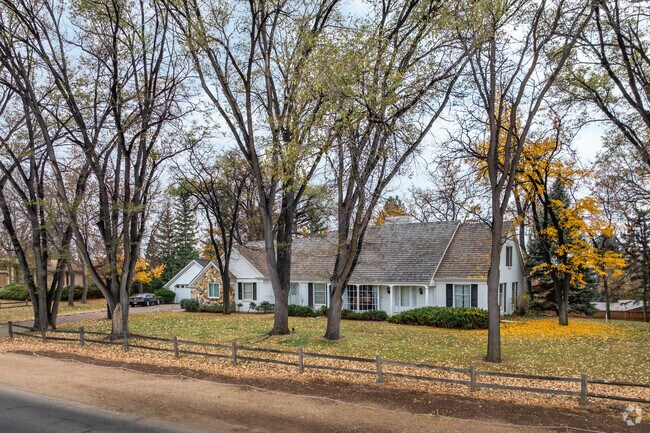 Matured trees tower over a lakeside home in Giddings.