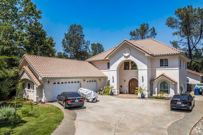 This 2-story Mediterranean inspired home has tile roof and large entryway in Goodwater.