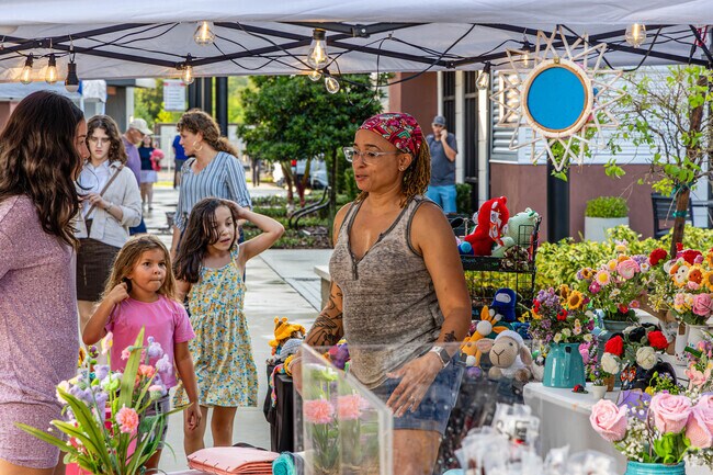 A vendor at a Bexley event at the Hub in Florida greets each passerby with a kind smile, offering not just flowers but a moment of beauty in their day.