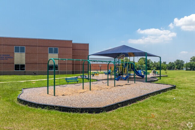 South Shaver Elementary is a clean campus with manicured lawns and covered bus ramp.