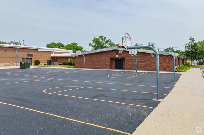Forest View Elementary School has several basketball hoops set up on pavement.