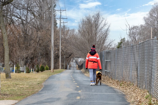Dog walkers, joggers, and cyclists are the primary users of the Cedar Lake Trail in Bronx Park.