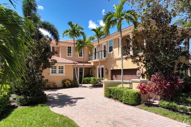 A luxury Mediterranean home with lush landscaping in the Evergene neighborhood.