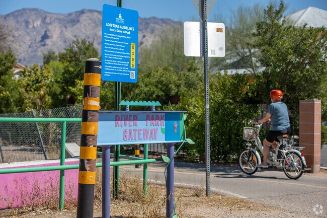 A Bicyclist Uses A Neighborhood Entrance To Access The Loop At The Rillito River Park