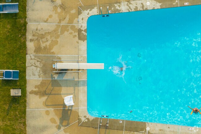 Splash into the pool from a jump off the diving board at the Concord Country Club.