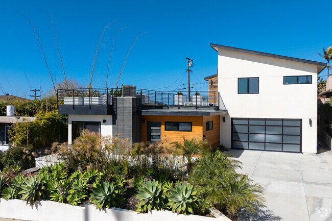 A modern custom home in Sunset Cliffs with a rooftop balcony.
