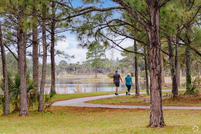 Abbey Park couple strolling through Okeeheelee Park's tree-lined trail.