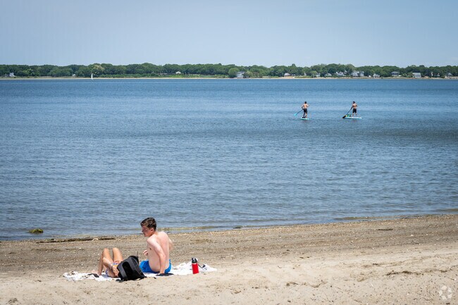 A young couple is enjoying Goddard Memorial State Park Beach in Nichols Corner, RI.