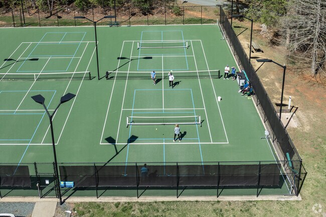 A group of Lake Monticello residents are having an intense game of Pickle Ball.