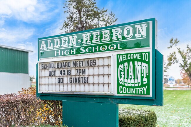 There is a sign outside of the Alden Hebron High School informing about upcoming events.