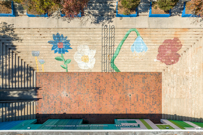 Thomasville Heights Elementary is vibrantly colored on the front, with flowers on the steps.
