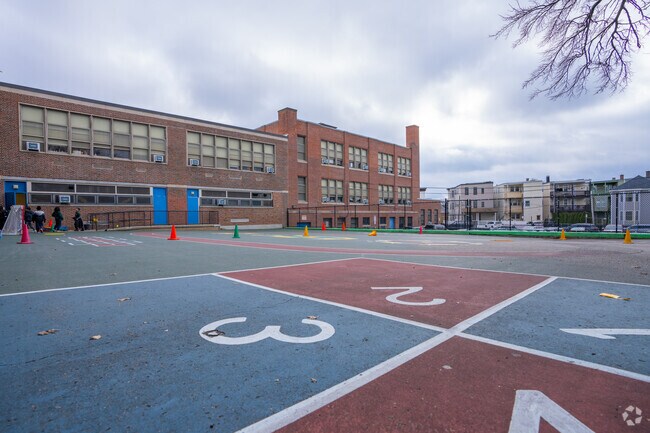 Kids are active in the schoolyard at Curtis Guild Elementary in Harbor View-Orient Heights.