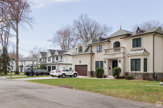 Newly constructed McMansions share the street with older Colonials in Demarest, NJ.