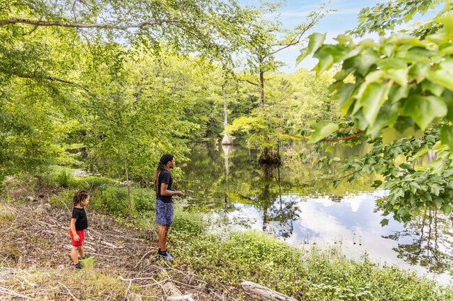 Father and son enjoy a quiet moment fishing near Cypress Cove Pond in Franklin, Virginia.