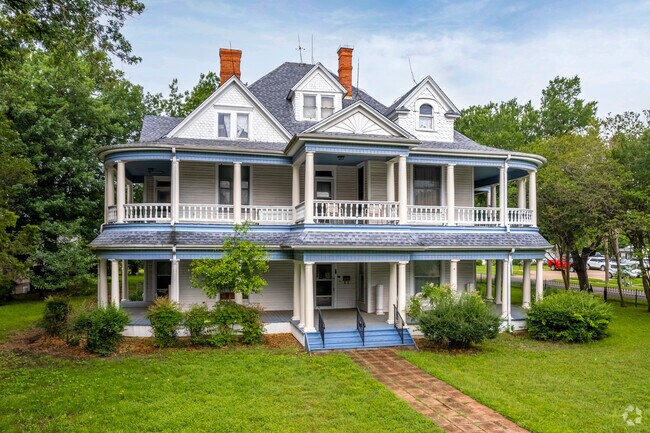 A beautiful, three story victorian home in Kaufman, TX where residents live.