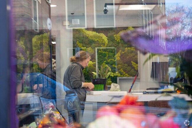 A florist at Perro's Flowers in Grafton Hill prepares a new flower bouquet.