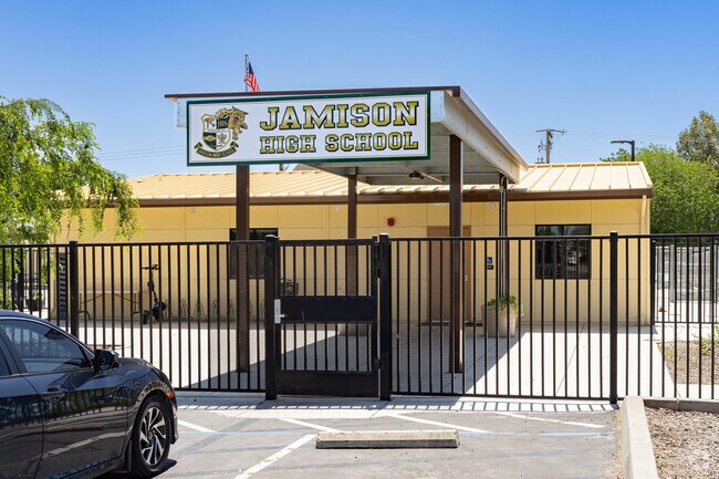 A large sign at the entrance of Donald C. Jamison High School welcomes visitors.